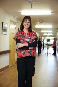 Picture of a smiling female Nurse standing in the hallway at Mayers Memorial Hospital